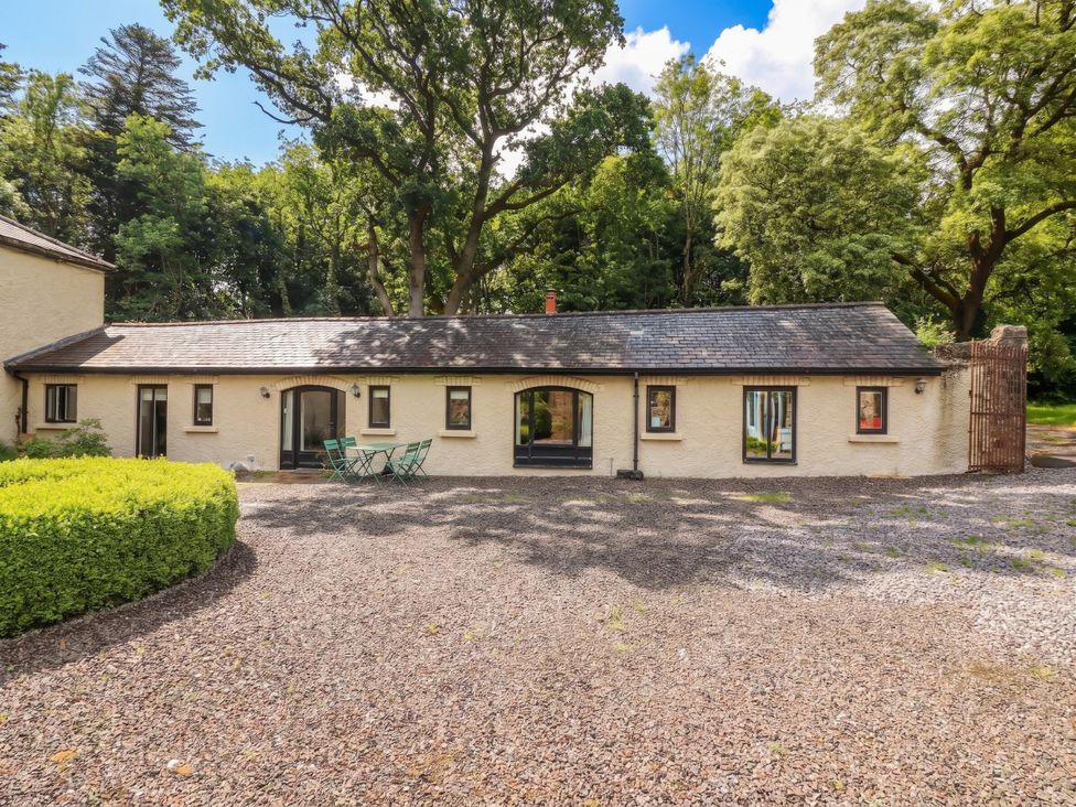 An outdoor view of a building with windows and doors at The Coach House Cottage Ballycommon