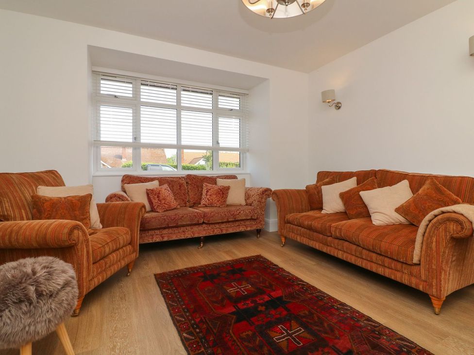 A living room with two sofas and a rug at Wendy's Cottage in Minehead