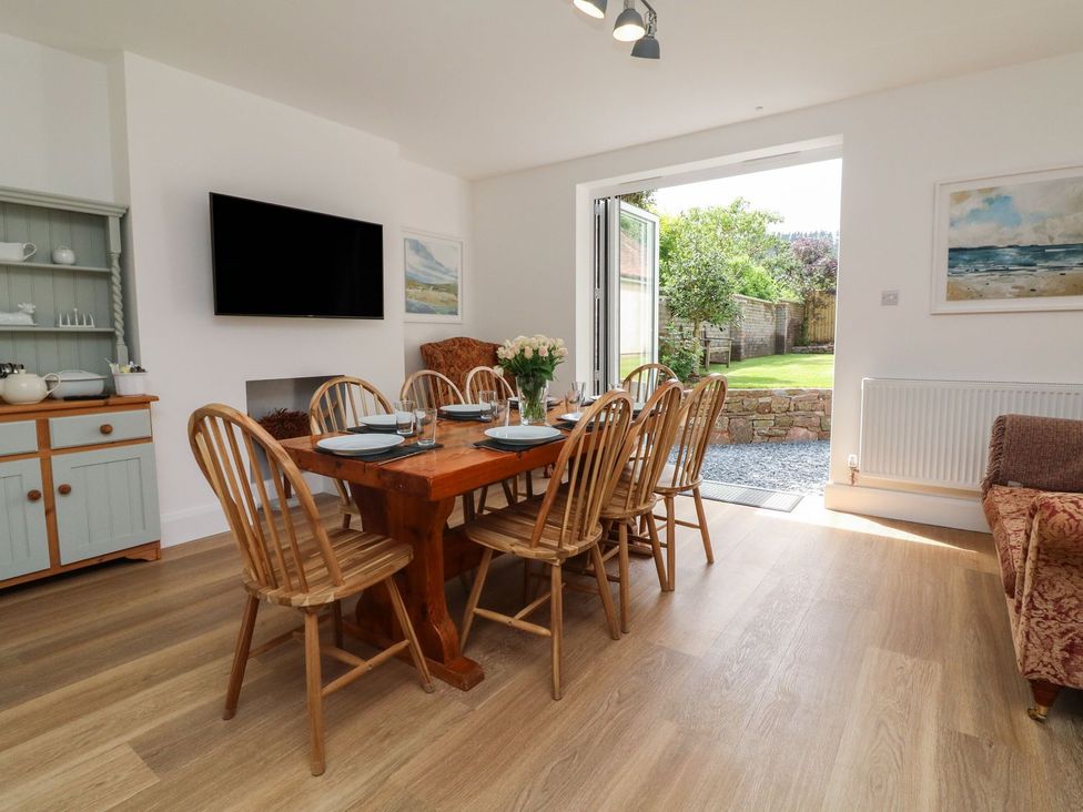 A dining room with a table and chairs at Wendy's Cottage in Minehead