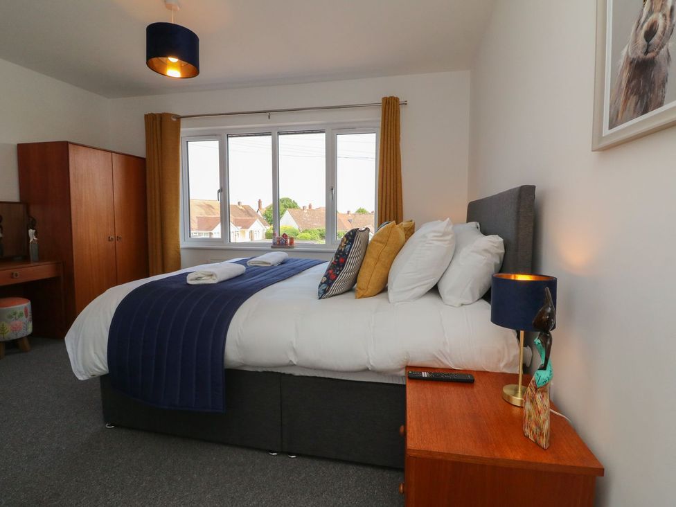A bedroom with a bed and dresser at Wendy's Cottage in Minehead