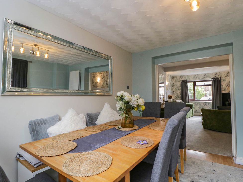 A dining room with a table set for meals at 1 Stanway Road