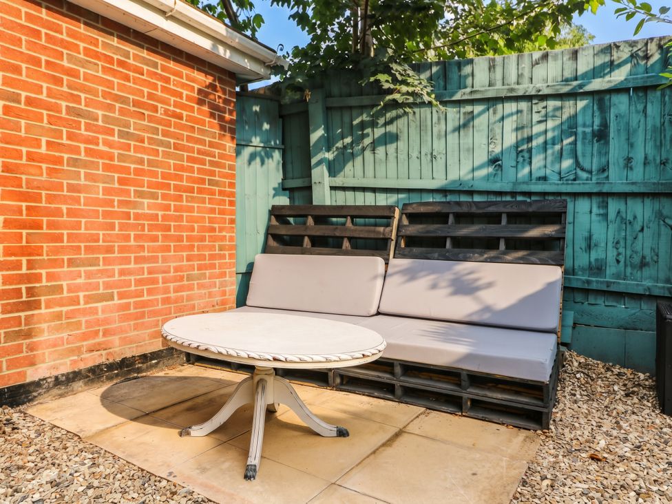 A garden with a table and sofa made from pallets at 1 Stanway Road