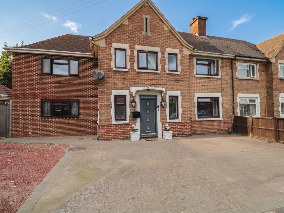 A brick house with a front door and windows at 1 Stanway Road