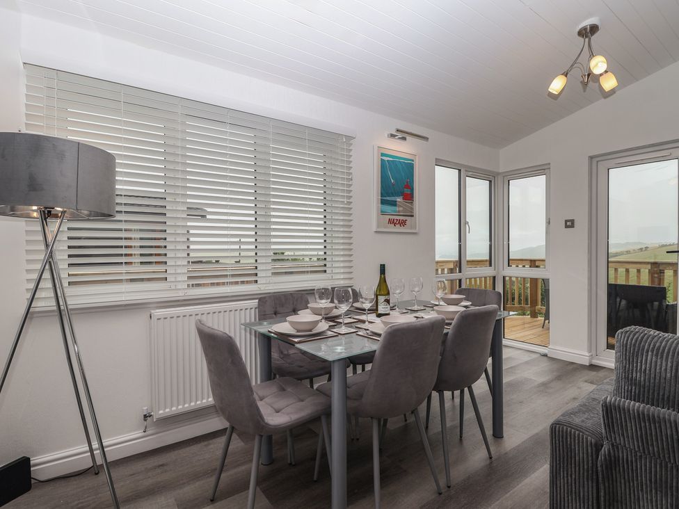 A dining room with a table set for a meal at Lodge 19 in Torpoint