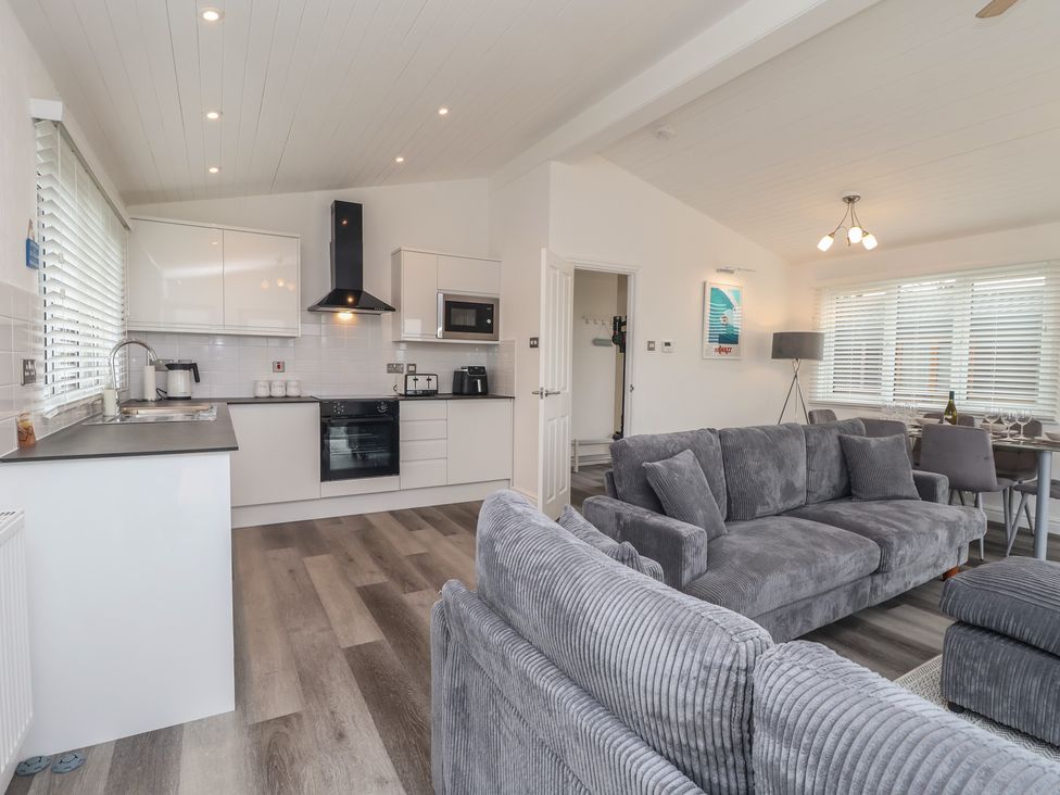 A kitchen with a dining area and seating at Lodge 19 Torpoint