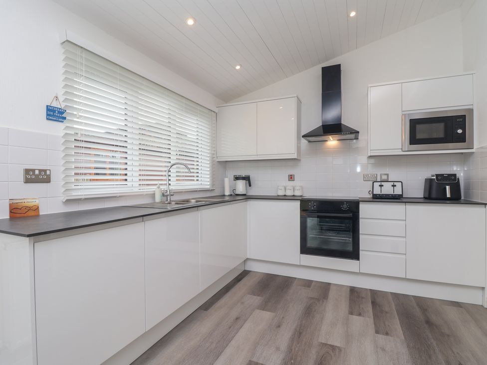 A kitchen with a sink and appliances at Lodge 19 in Torpoint