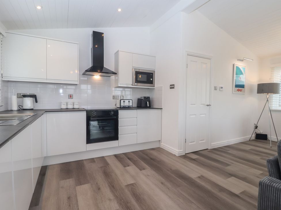 A kitchen with modern appliances at Lodge 19 in Torpoint