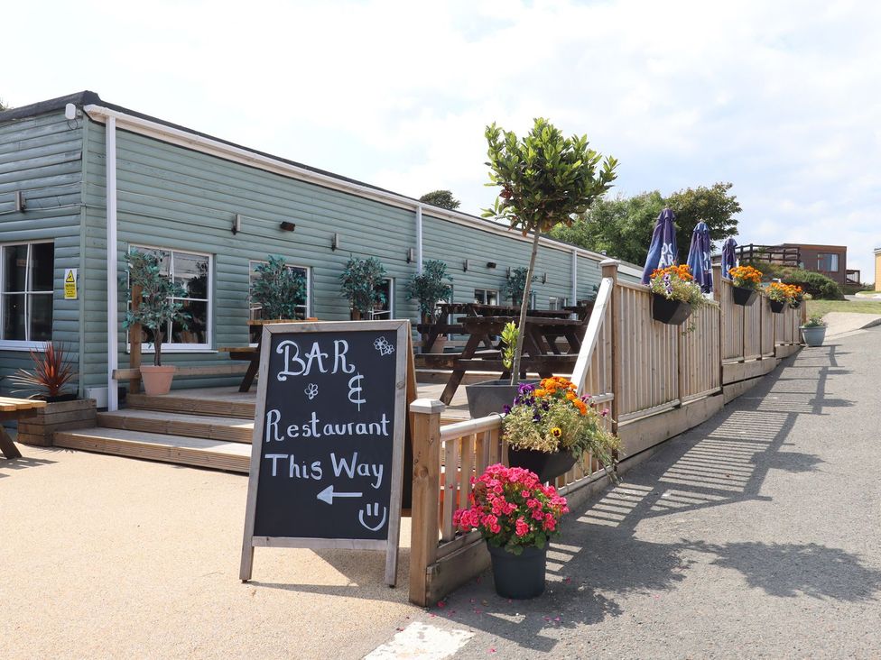 An outdoor area with a sign for the bar and restaurant at Lodge 19 in Torpoint