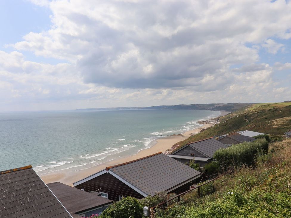 A view of the sea and beach with houses at Lodge 19 in Torpoint