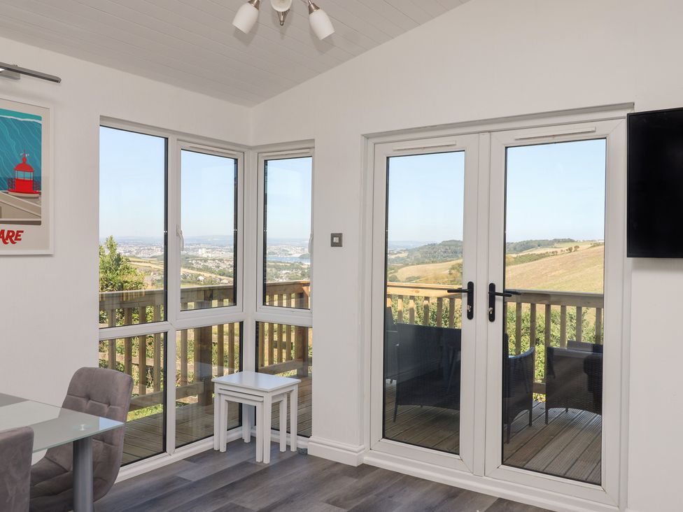 A sunroom with windows and a door at Lodge 19 in Millbrook