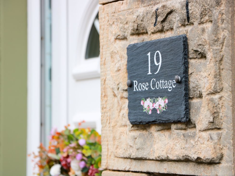 A name plate on a stone wall at 19 Rose Cottage in Peebles