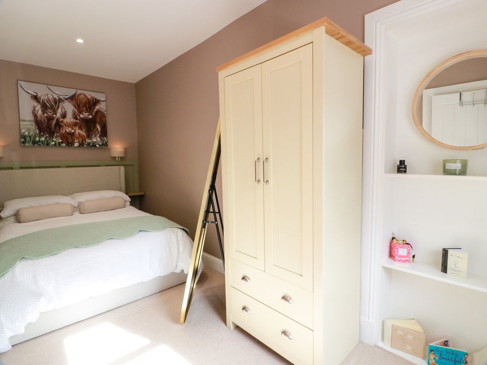 A bedroom with a bed and wardrobe at 19 Biggiesknowe in Peebles
