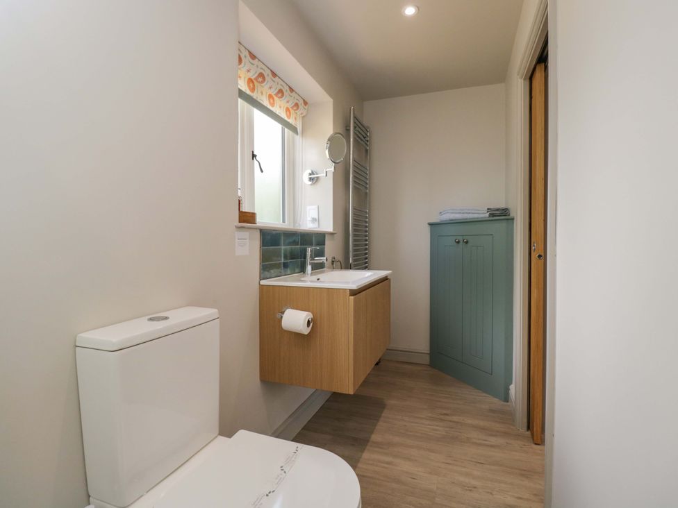 A bathroom with a toilet and sink at Poppy Patch in Stratton Audley near Bicester