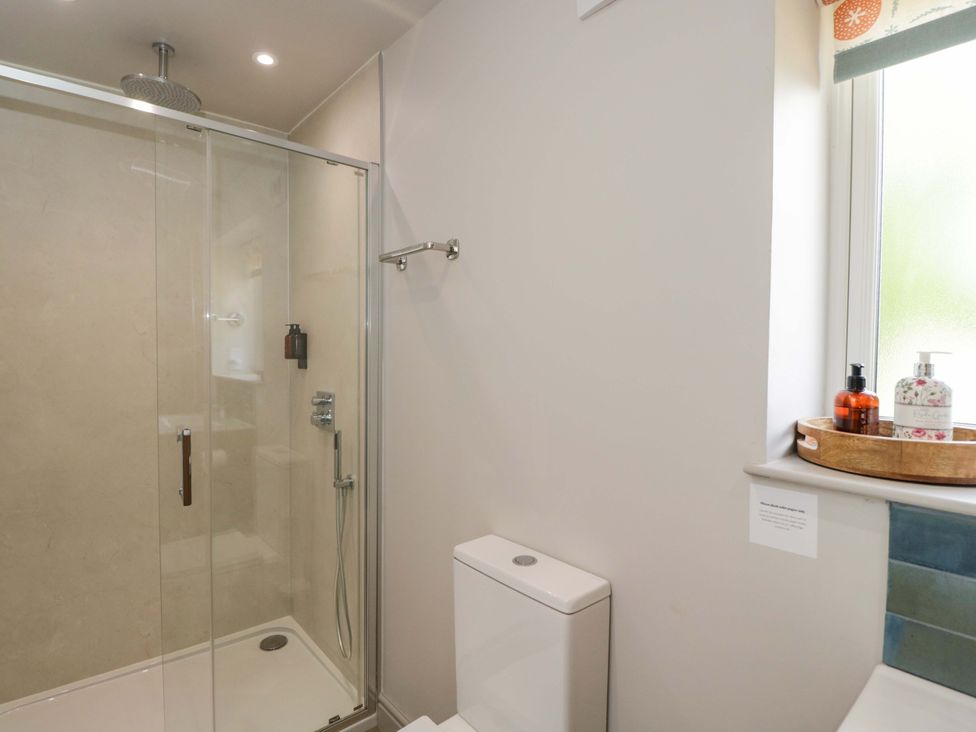 A bathroom with a shower and toilet at Poppy Patch in Stratton Audley near Bicester