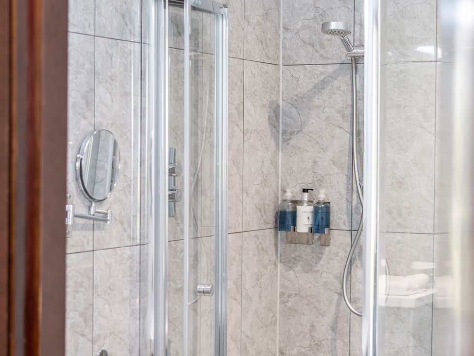 A shower with a mirror and soap dispenser at Cotswolds Apartment, sleeps 4 in Chipping Norton