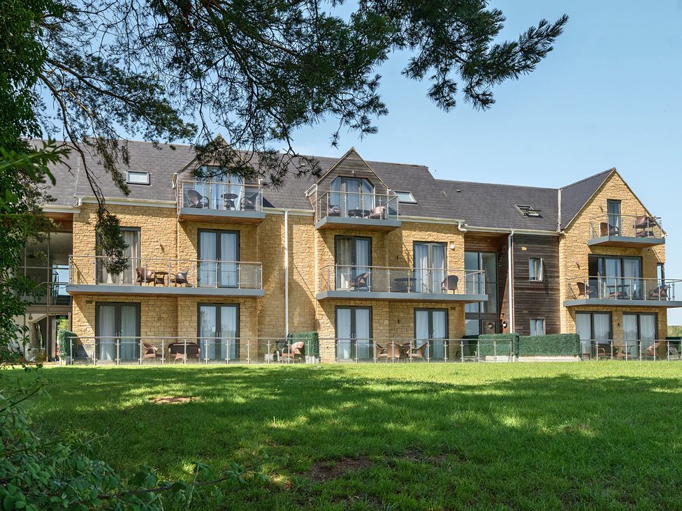 A building with balconies and grass at Cotswolds Apartment, sleeps 4, Chipping Norton