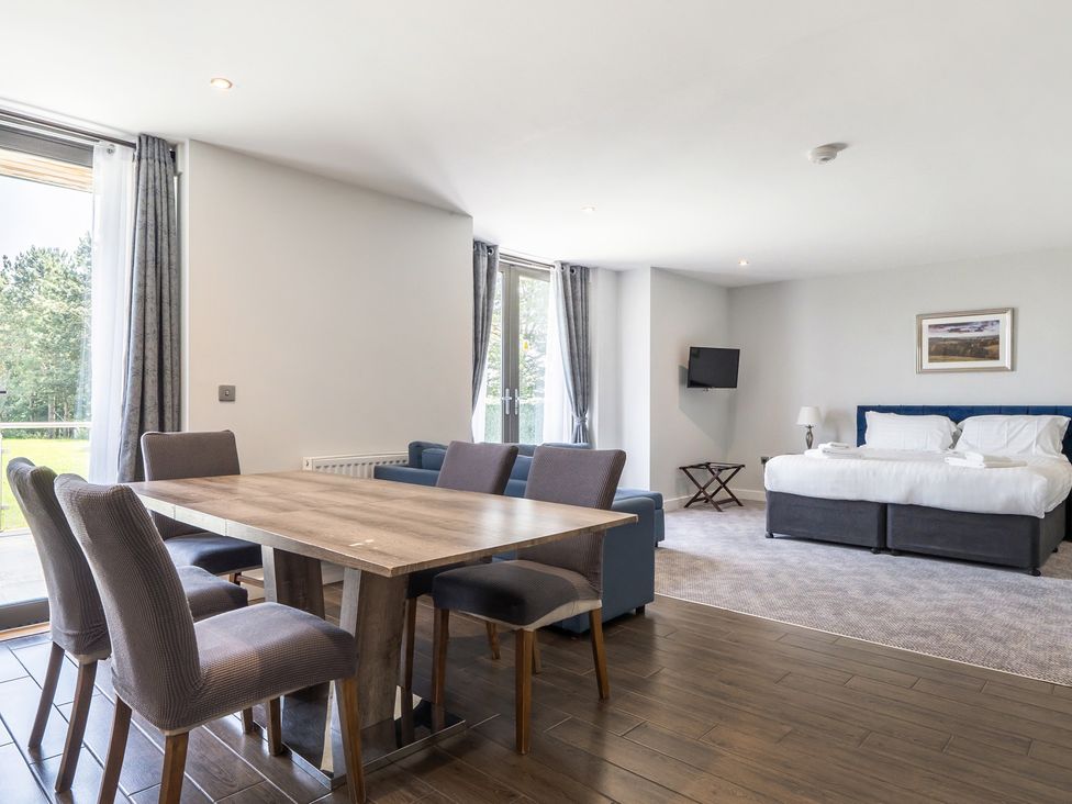 A living room with a dining area and a sofa at Cotswolds Apartments 2B/S4 in Chipping Norton