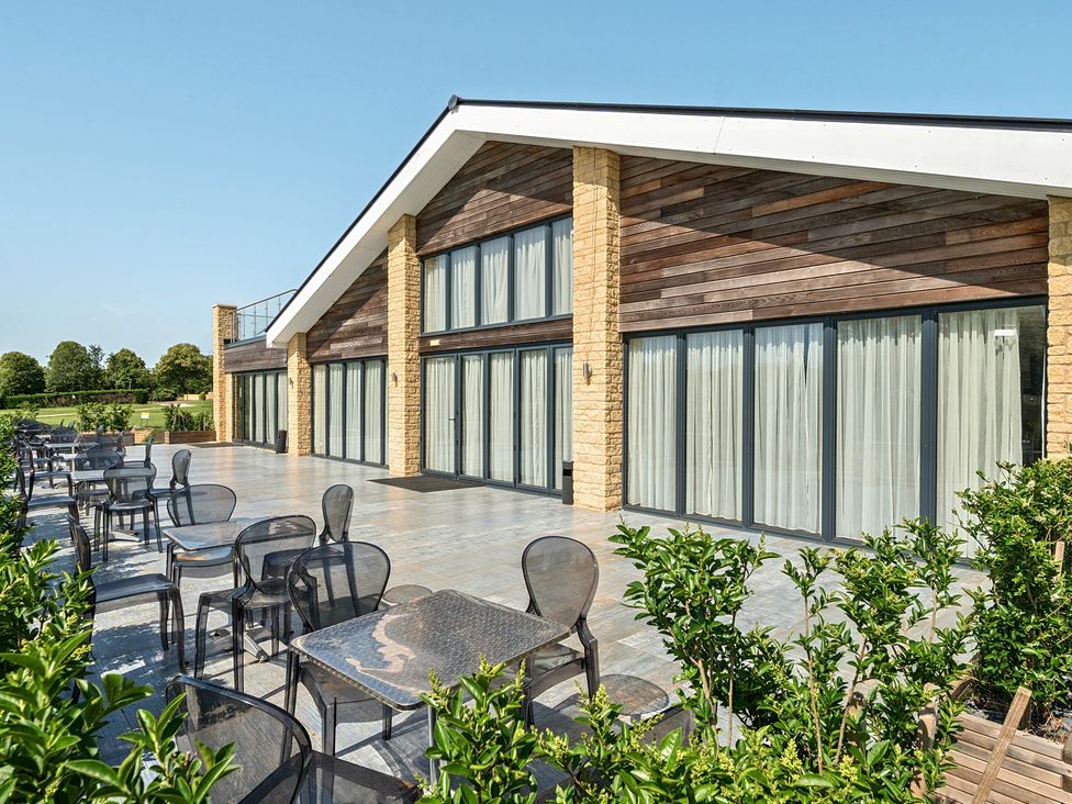 An outdoor area with chairs and plants at Cotswolds Apartments 2B/S4 in Chipping Norton