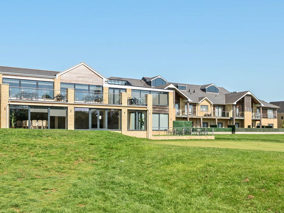 A building with balconies and outdoor seating at Cotswolds Apartments 2B/S4 in Chipping Norton