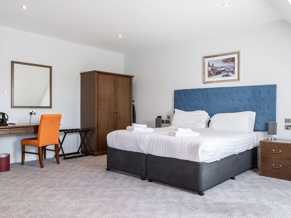 A bedroom with a bed and desk at Cotswolds Apartments 4B/S8 Chipping Norton