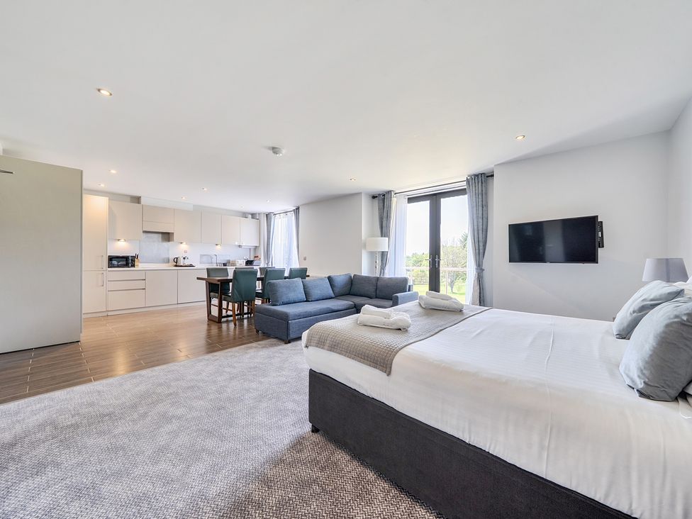 A living room with a bed and sofa at Cotswolds Apartments 4B/S8 in Chipping Norton