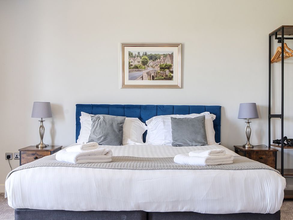A bedroom with a bed and nightstands at Cotswolds Apartments 4B/S8, Chipping Norton