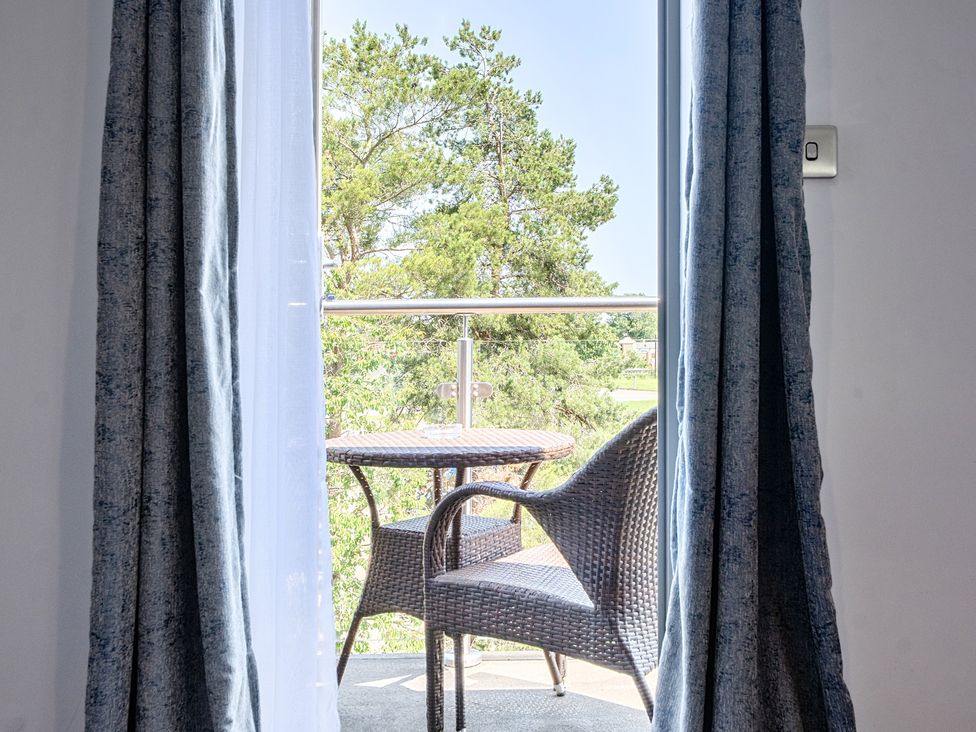 A balcony with a table and chair at Cotswolds Apartments 4B/S8 in Chipping Norton