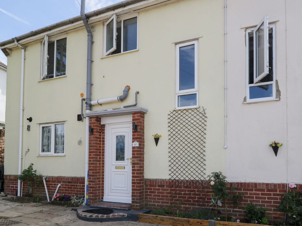A front exterior view of a house with a white door at 167 Leybourne Avenue in Bournemouth