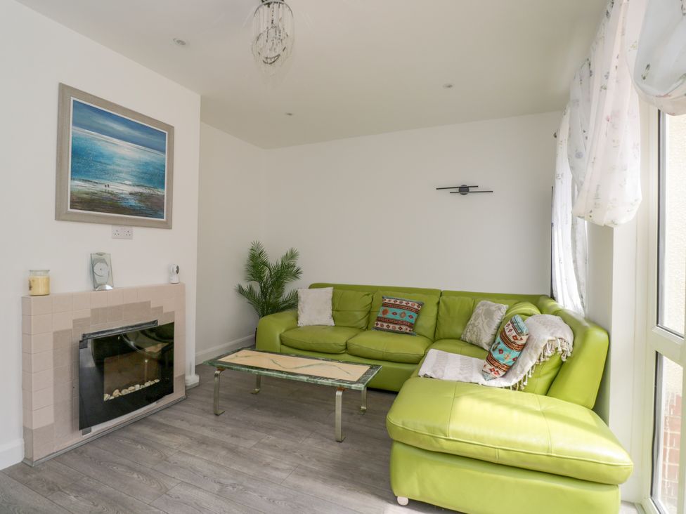 A living room with a green sofa and coffee table at 167 Leybourne Avenue in Bournemouth