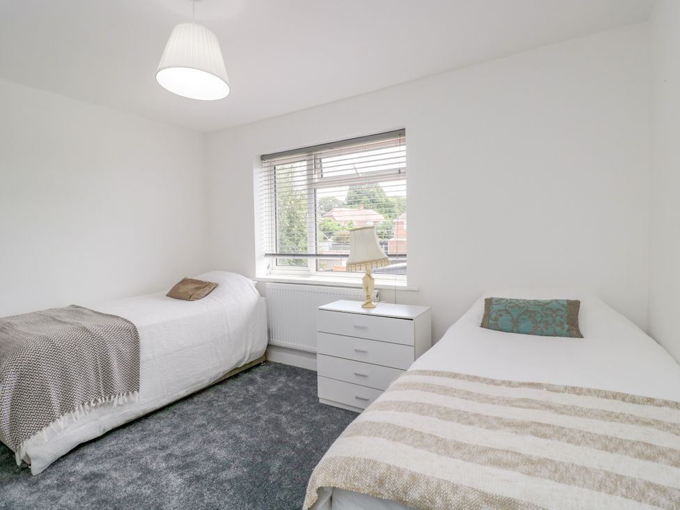 A bedroom with two beds and a dresser at 167 Leybourne Avenue Bournemouth