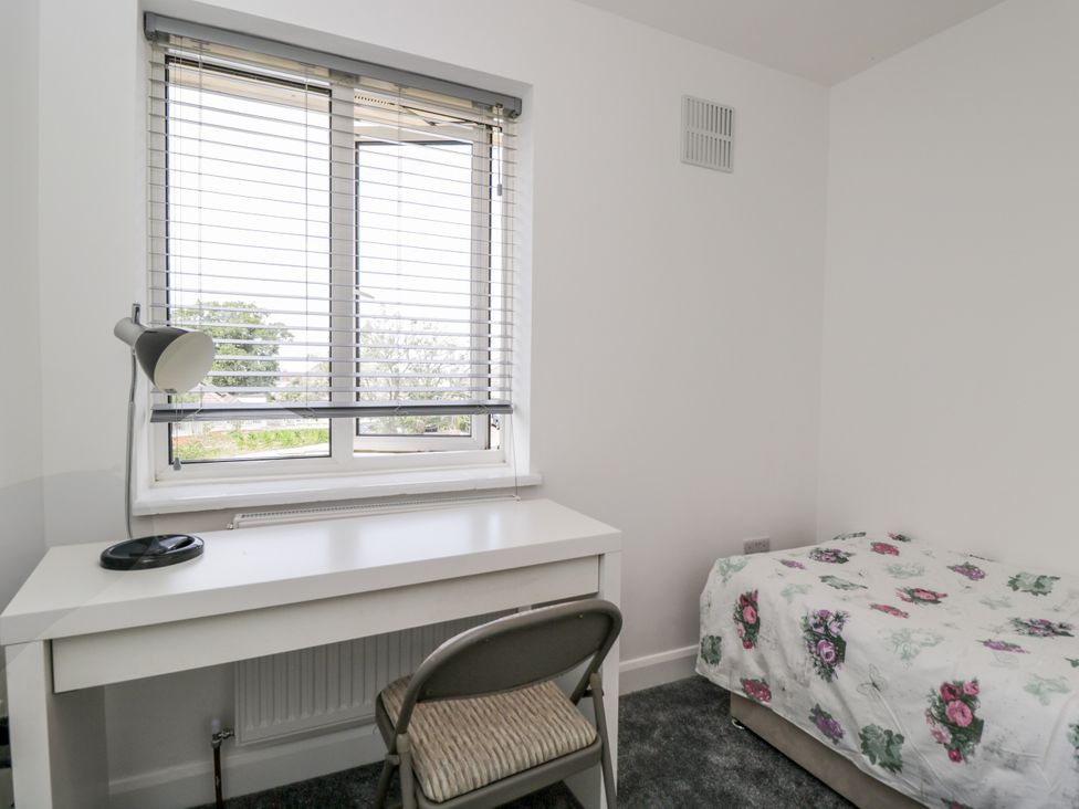 A bedroom with a desk, chair, bed and window at 167 Leybourne Avenue in Bournemouth