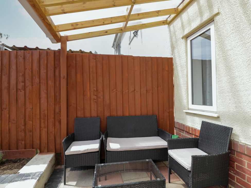 A garden seating area with a table and chairs at 167 Leybourne Avenue Bournemouth