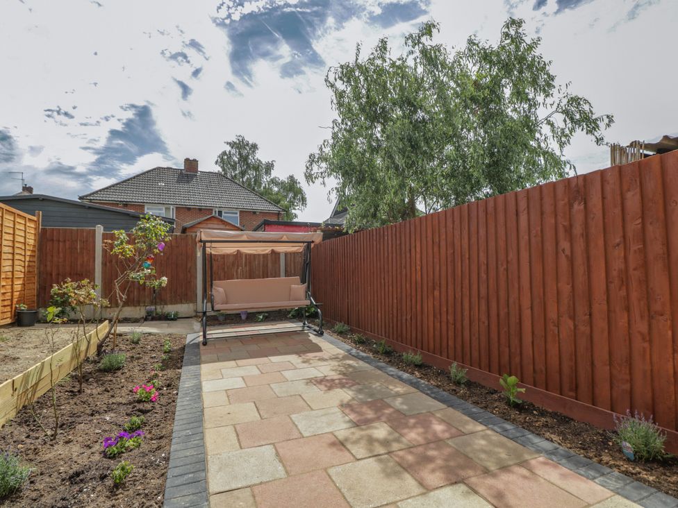 A garden with a pathway and seating at 167 Leybourne Avenue in Bournemouth