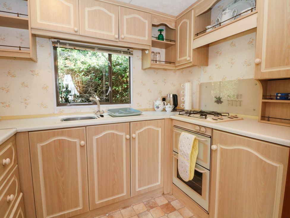 A kitchen with a sink and cooking range at Buzzards Retreat in Wrexham