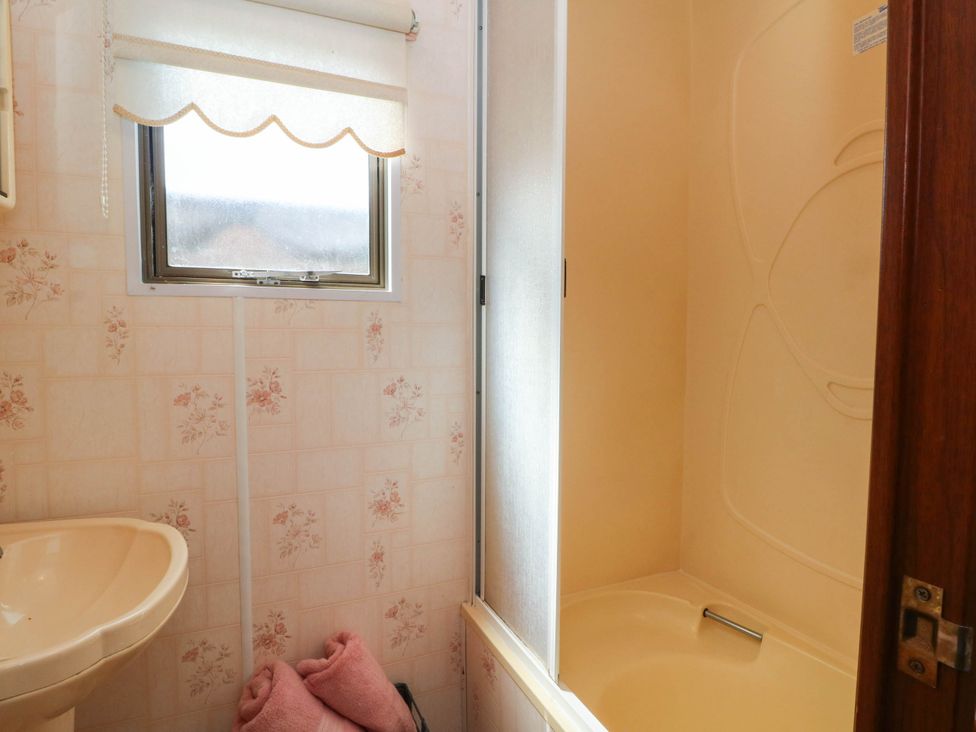A bathroom with a sink and shower at Buzzards Retreat in Wrexham
