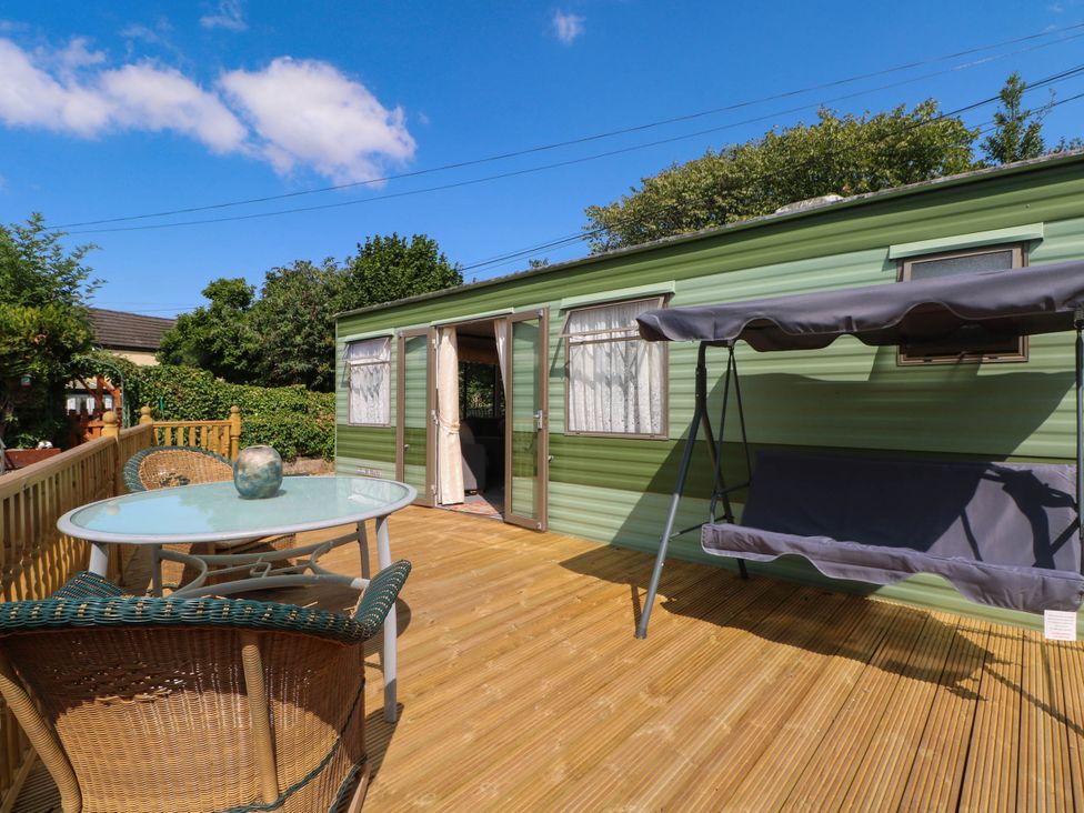 An outdoor seating area with a table and chairs at Buzzards Retreat Wrexham