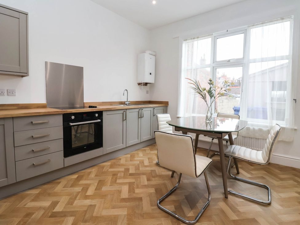 A kitchen with cabinets and a table at 154 Queen Street in Withernsea