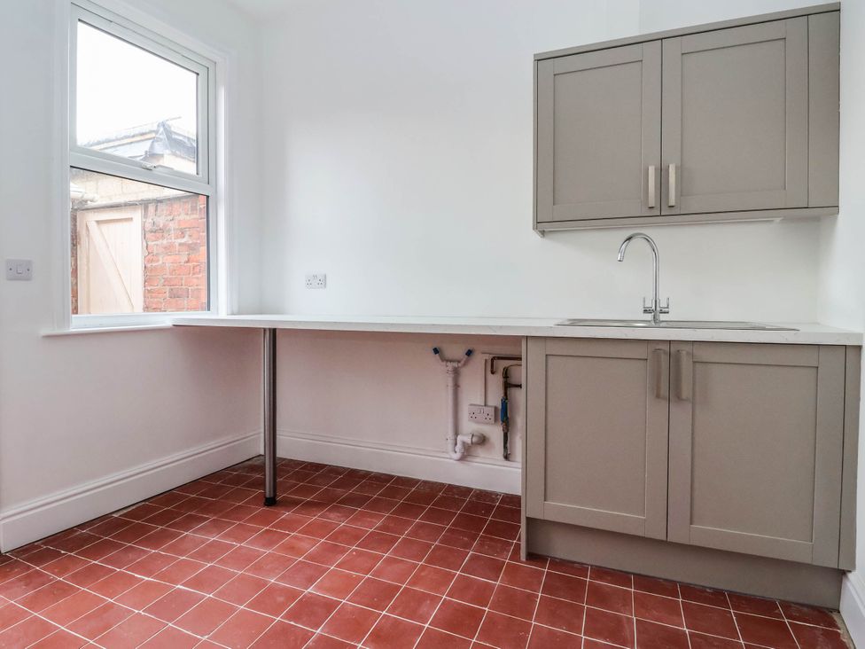 A kitchen with a sink and cabinets at 154 Queen Street in Withernsea