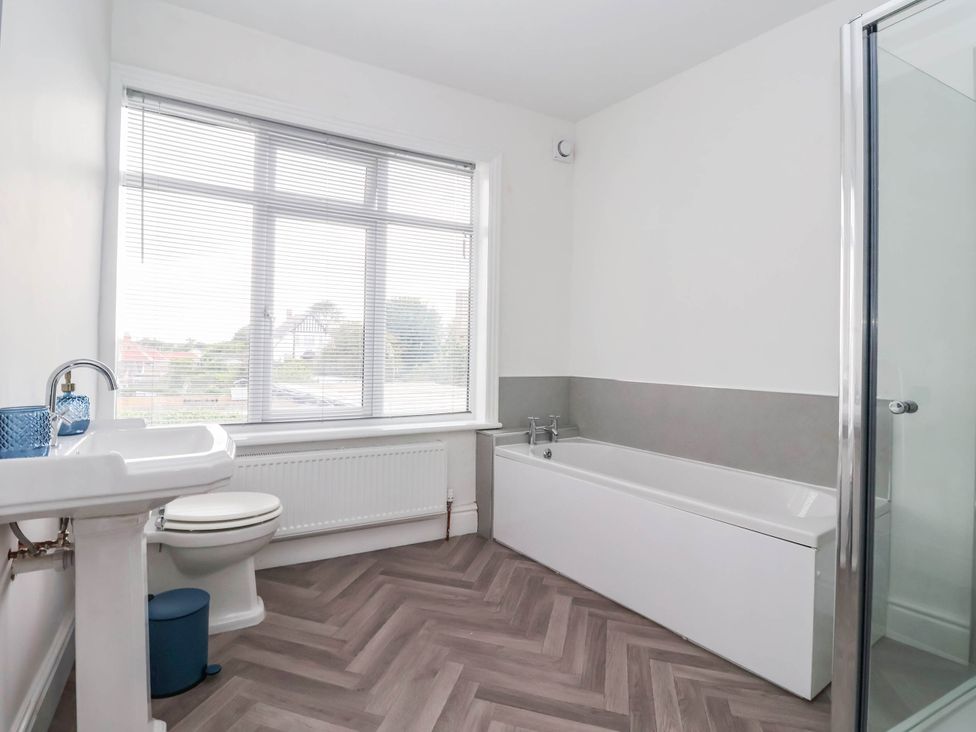 A bathroom featuring a sink, toilet, bathtub, and shower at 154 Queen Street in Withernsea