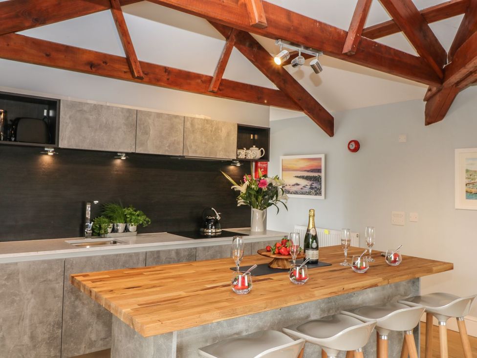 A kitchen with a wooden counter and bar stools at Argal in Treverva near Constantine