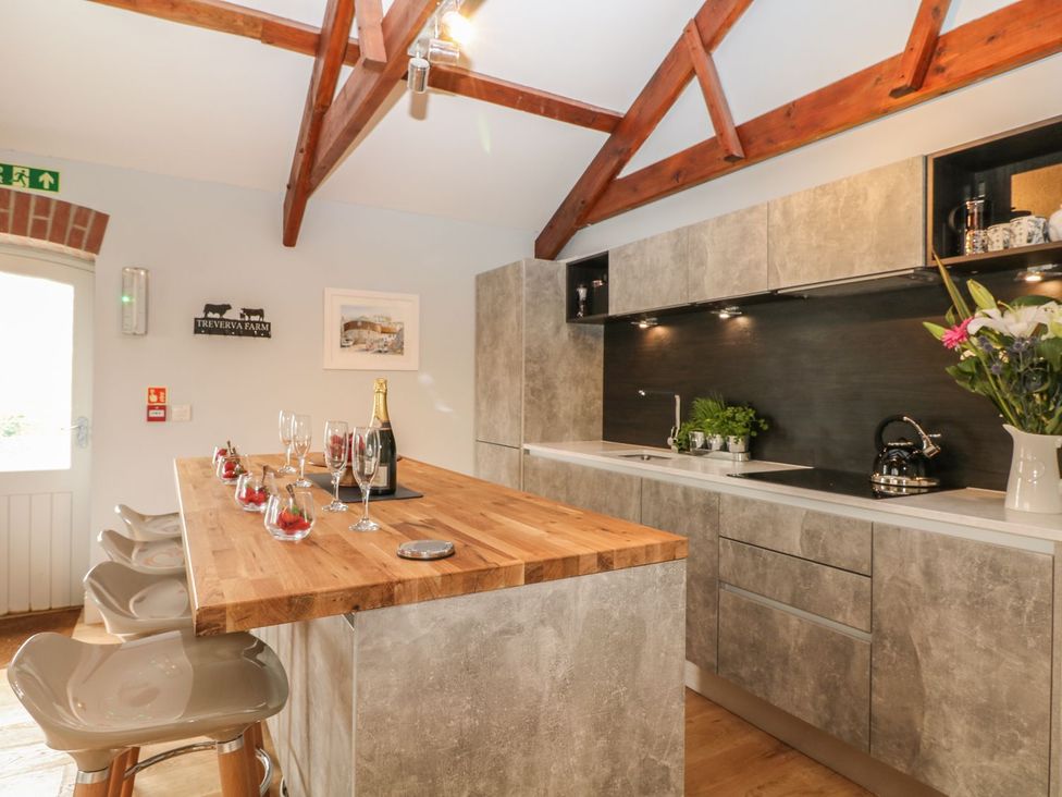 A kitchen with bar stools and a countertop at Argal in Treverva near Constantine