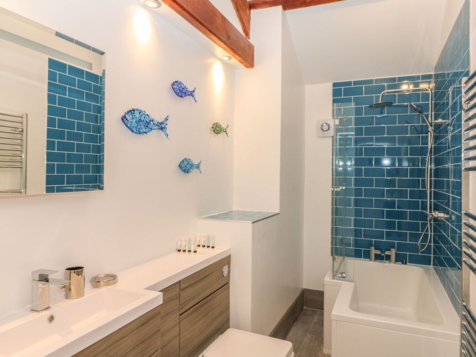 A bathroom featuring a bathtub and shower at Argal near Treverva