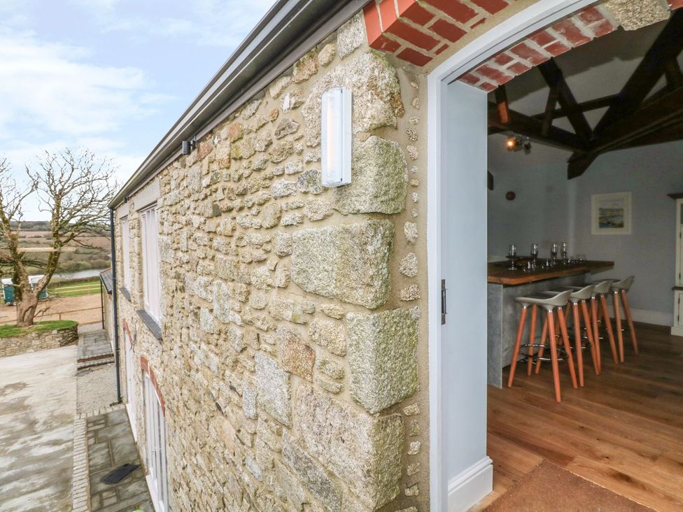 A stone wall and door leading to a bar area at Argal in Treverva near Constantine