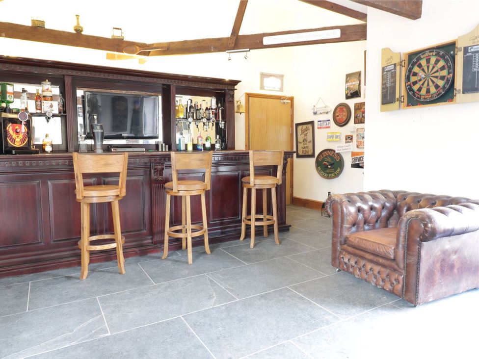 A games room with a bar and dartboard at Argal in Treverva near Constantine