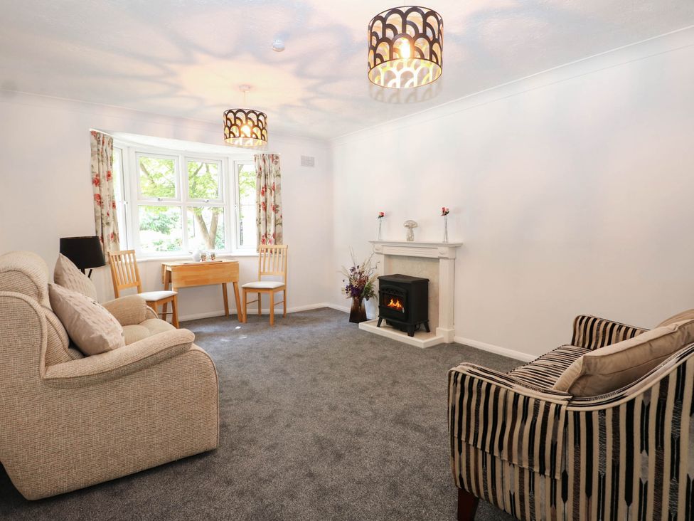 A living room with a fireplace and seating area at 44 Court Road in Lewes, Sussex