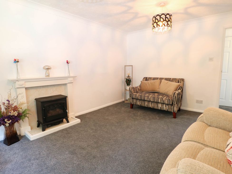 A living room with a fireplace and a sofa at 44 Court Road in Lewes, Sussex