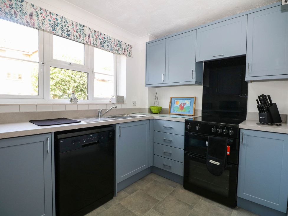 A kitchen featuring a sink, dishwasher, and oven at 44 Court Road, Lewes, Sussex