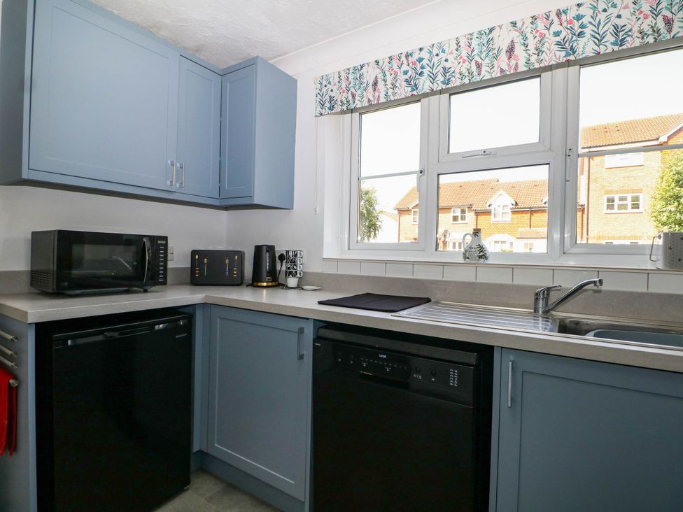 A kitchen with a microwave, toaster, and sink at 44 Court Road in Lewes, Sussex