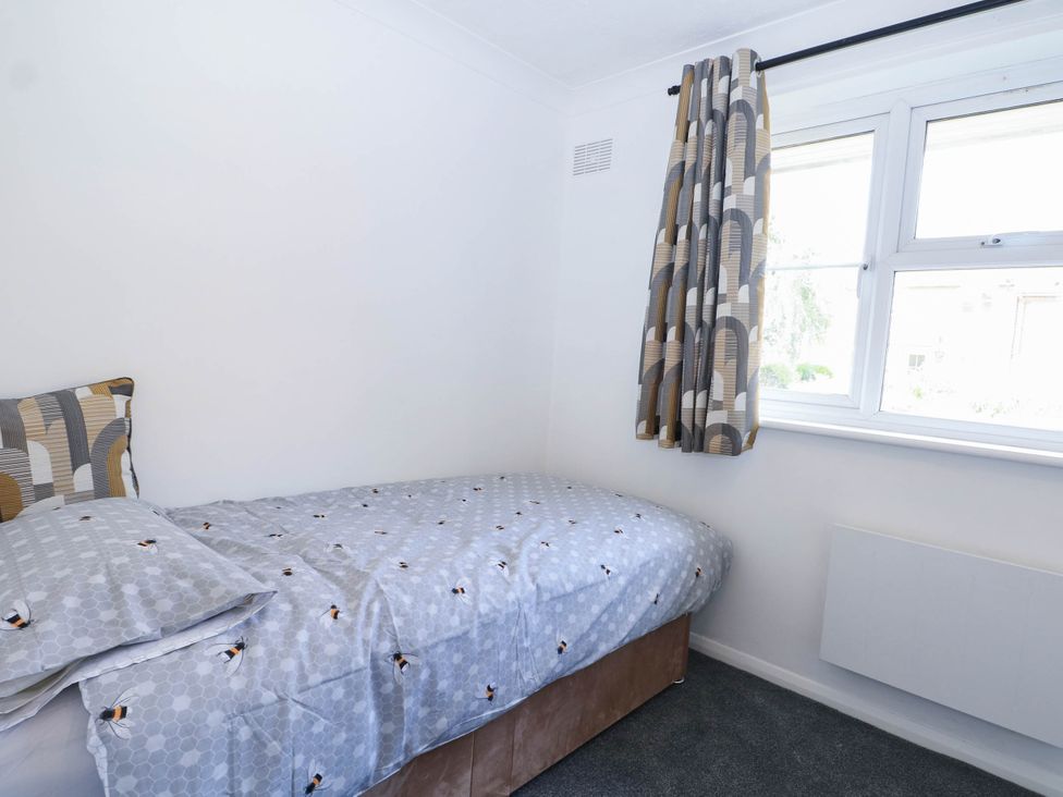 A bedroom with a bed and window at 44 Court Road, Lewes, Sussex