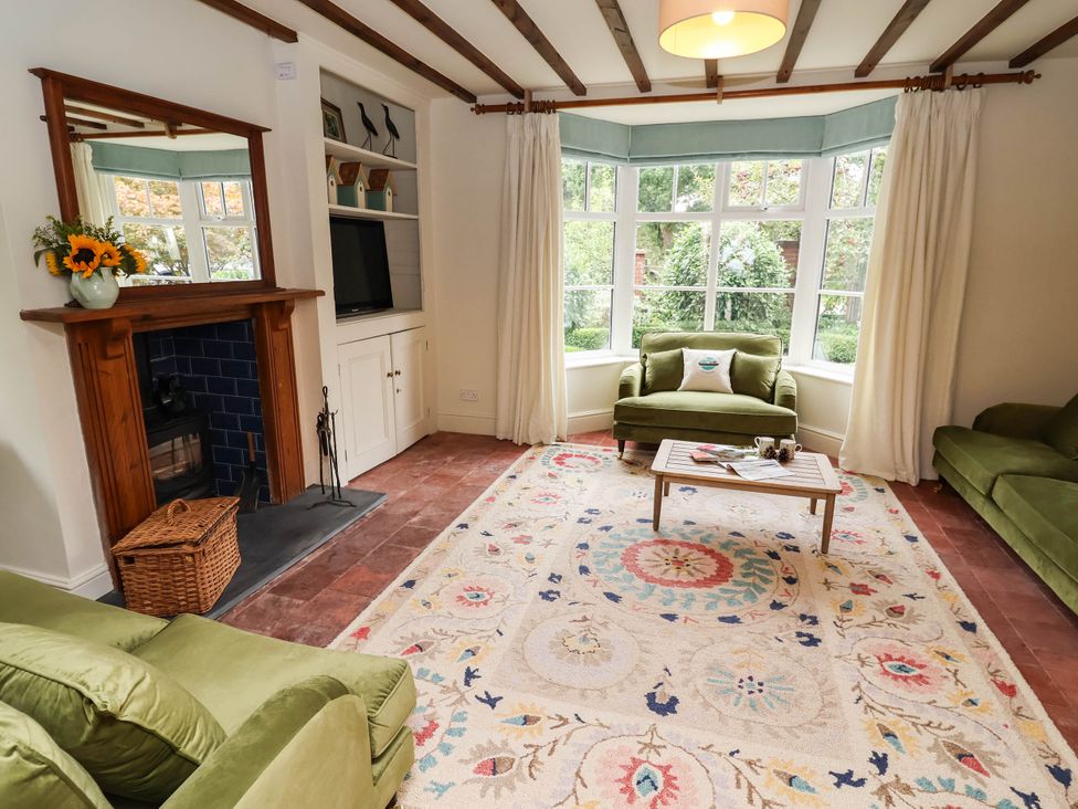 A living room with sofas and a coffee table at Lyneal Cottage in Ellesmere